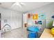 Bright bedroom with neutral walls, tile flooring, and a large closet at 9752 County Road 121, Wildwood, FL 34785