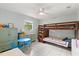 Charming bedroom features a bunk bed, tile flooring, and light blue walls at 9752 County Road 121, Wildwood, FL 34785
