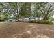 Single story brick home with charming blue shutters and a welcoming pergola in the front yard at 9752 County Road 121, Wildwood, FL 34785