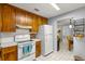 Functional kitchen with classic appliances, ample cabinet space, and a view into the dining area at 9752 County Road 121, Wildwood, FL 34785