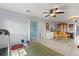 Open living room featuring tile floors, ceiling fan and bright natural light at 9752 County Road 121, Wildwood, FL 34785
