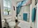 Clean bathroom with a shower-tub combination, decorative curtains, and modern fixtures at 102 Dogwood Trl, Leesburg, FL 34748
