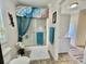 Functional bathroom with a shower-tub, adjacent to laundry area with a washer and dryer at 102 Dogwood Trl, Leesburg, FL 34748
