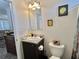 This bathroom features a sleek vanity and decorative wall art, located next to the living area at 102 Dogwood Trl, Leesburg, FL 34748