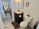 Bathroom with dark vanity and beige tile flooring, adjacent to a living area at 102 Dogwood Trl, Leesburg, FL 34748