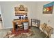 Bedroom featuring a wooden desk setup, decorative painting and hats on the wall, and room for a floor mattress at 102 Dogwood Trl, Leesburg, FL 34748