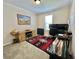 Bedroom with a rustic cabinet under the window and a desk area with a computer setup for an office space at 102 Dogwood Trl, Leesburg, FL 34748