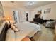 Well-lit bedroom featuring a comfortable bed, an organized closet, and a TV for entertainment at 102 Dogwood Trl, Leesburg, FL 34748