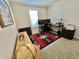 Bedroom featuring a desk area with a computer setup and a rustic cabinet under the window at 102 Dogwood Trl, Leesburg, FL 34748