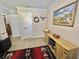 Bedroom showcasing a decorative painting, a rustic cabinet, and an open door to a hallway with the bathroom visible at 102 Dogwood Trl, Leesburg, FL 34748
