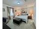 Cozy bedroom featuring a plush bed, neutral tones, and an ottoman for additional comfort at 102 Dogwood Trl, Leesburg, FL 34748