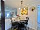Sunlit dining area featuring sunflower artwork and adjacent access to the laundry room at 102 Dogwood Trl, Leesburg, FL 34748