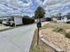 Pleasant exterior view showcasing the long driveway, landscaping, and mailbox, adding curb appeal at 102 Dogwood Trl, Leesburg, FL 34748