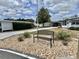 Exterior view with tasteful landscaping and a comfortable park bench, enhancing outdoor living at 102 Dogwood Trl, Leesburg, FL 34748
