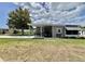 Home with covered parking for a golf cart on a well-maintained lot at 102 Dogwood Trl, Leesburg, FL 34748