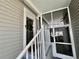 Welcoming entrance with a covered porch, metal railings, and access to a screened porch at 102 Dogwood Trl, Leesburg, FL 34748