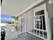 Inviting entrance with a covered porch, metal railings, and a view of the community at 102 Dogwood Trl, Leesburg, FL 34748
