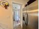 View of the laundry room with stackable washer and dryer, accessible from the kitchen at 102 Dogwood Trl, Leesburg, FL 34748