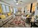 Inviting living room featuring comfortable seating, a stylish rug, and lots of natural light from the windows at 102 Dogwood Trl, Leesburg, FL 34748