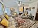 Open-concept living room with comfortable seating, neutral decor, and a view to the kitchen at 102 Dogwood Trl, Leesburg, FL 34748