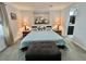 Cozy main bedroom with neutral colors, a decorative painting above the bed, and access to the en-suite bathroom at 102 Dogwood Trl, Leesburg, FL 34748