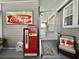 Cozy screened-in porch featuring a vintage Coca-Cola machine and access to the house at 102 Dogwood Trl, Leesburg, FL 34748