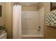 A bathtub and shower combination featuring a white shower curtain and neutral wall color at 1070 Pinewood Pl, The Villages, FL 32162