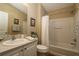 Clean bathroom with a tub, shower, and vanity with countertop and sink at 1070 Pinewood Pl, The Villages, FL 32162