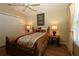 Charming bedroom with ceiling fan, natural light, wood laminate flooring, and double door closet at 1070 Pinewood Pl, The Villages, FL 32162