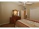 Primary bedroom featuring ceiling fan, wood laminate flooring and vanity with mirror at 1070 Pinewood Pl, The Villages, FL 32162