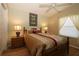 Cozy bedroom featuring natural light, neutral paint, ceiling fan and wood laminate flooring at 1070 Pinewood Pl, The Villages, FL 32162