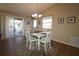 Bright dining area features a chandelier, wooden floors, and a sliding glass door at 1070 Pinewood Pl, The Villages, FL 32162