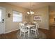 Bright dining area features a chandelier, wooden floors, and natural light at 1070 Pinewood Pl, The Villages, FL 32162