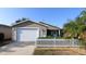Exterior featuring a two-car garage and front yard at 1070 Pinewood Pl, The Villages, FL 32162