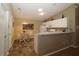 Modern kitchen with white cabinets, a dining area, and stainless steel appliances at 1070 Pinewood Pl, The Villages, FL 32162