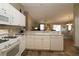 Open kitchen featuring white cabinets, corian countertops, and stainless appliances at 1070 Pinewood Pl, The Villages, FL 32162