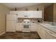 Bright kitchen featuring white cabinets, ample counter space, and modern appliances at 1070 Pinewood Pl, The Villages, FL 32162