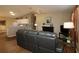 Living room with a leather sofa, and open access to the kitchen at 1070 Pinewood Pl, The Villages, FL 32162