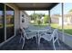 Screened lanai with a table, four chairs, and exterior views at 1070 Pinewood Pl, The Villages, FL 32162