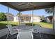 The lanai features a ceiling fan, patio furniture and views of the backyard at 1070 Pinewood Pl, The Villages, FL 32162