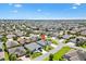 Expansive aerial shot showcasing a peaceful residential neighborhood with lush greenery and neatly arranged homes at 1182 Allaire Loop, The Villages, FL 32163