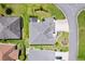 Aerial view of well-maintained home featuring mature landscaping, neutral-colored roof, and enclosed lanai at 1182 Allaire Loop, The Villages, FL 32163