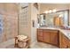 Bright bathroom features a glass block window, vanity with ample storage and tile shower at 1182 Allaire Loop, The Villages, FL 32163