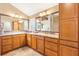 Bathroom boasts dual sinks, spacious vanity, and abundant cabinet storage for optimal organization at 1182 Allaire Loop, The Villages, FL 32163