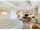 Comfortable bedroom with a ceiling fan, a closet, and a desk area for work or study at 1182 Allaire Loop, The Villages, FL 32163