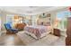 Spacious bedroom features tray ceilings, natural light, and ample room for a relaxing sitting area at 1182 Allaire Loop, The Villages, FL 32163