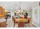 Bright dining area featuring a round table and chairs, seamlessly blending into the living room at 1182 Allaire Loop, The Villages, FL 32163