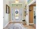 Welcoming foyer with tile flooring, decorative rug, and ample natural light at 1182 Allaire Loop, The Villages, FL 32163