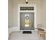 Close-up of the front door with decorative glass and covered entrance at 1182 Allaire Loop, The Villages, FL 32163
