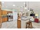 Open kitchen features stainless steel appliances, granite countertops, breakfast bar and ample cabinet space at 1182 Allaire Loop, The Villages, FL 32163